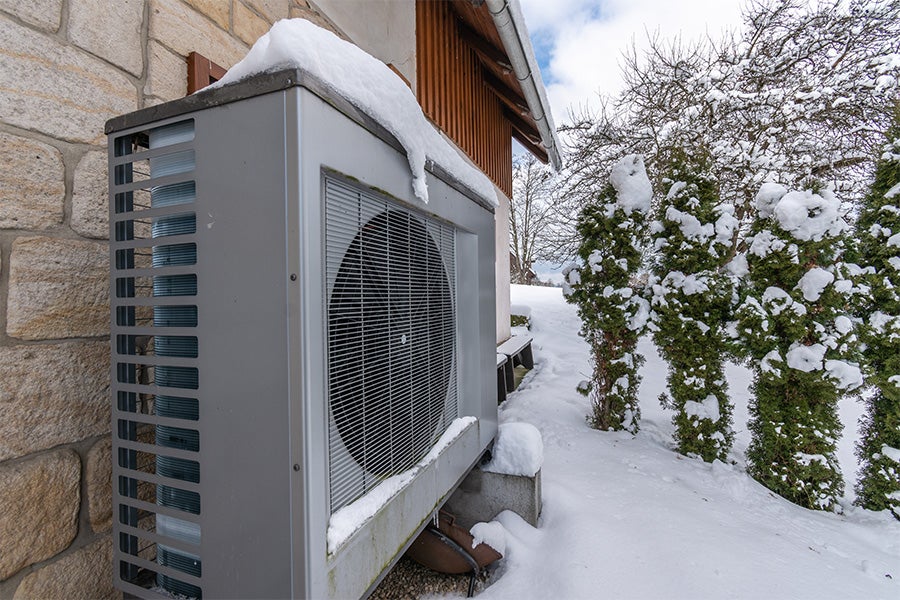 Cold-climate heat pump outdoor unit operating in winter snow